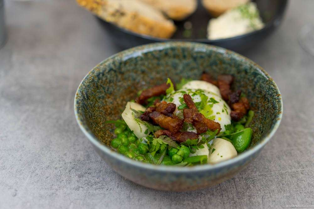 Poached egg, fresh green peas and sugar snaps, salty bacon and butter sauce