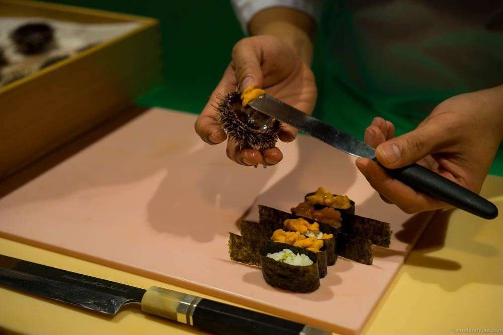 Carefully scooping out the genitals. Yes, that's the part you eat.