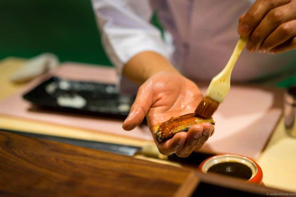 The eel is brushed with an unagi sauce by Roger