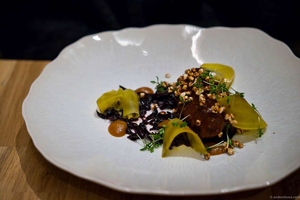 Braised pork cheeks with burnt cabbage and onion cream