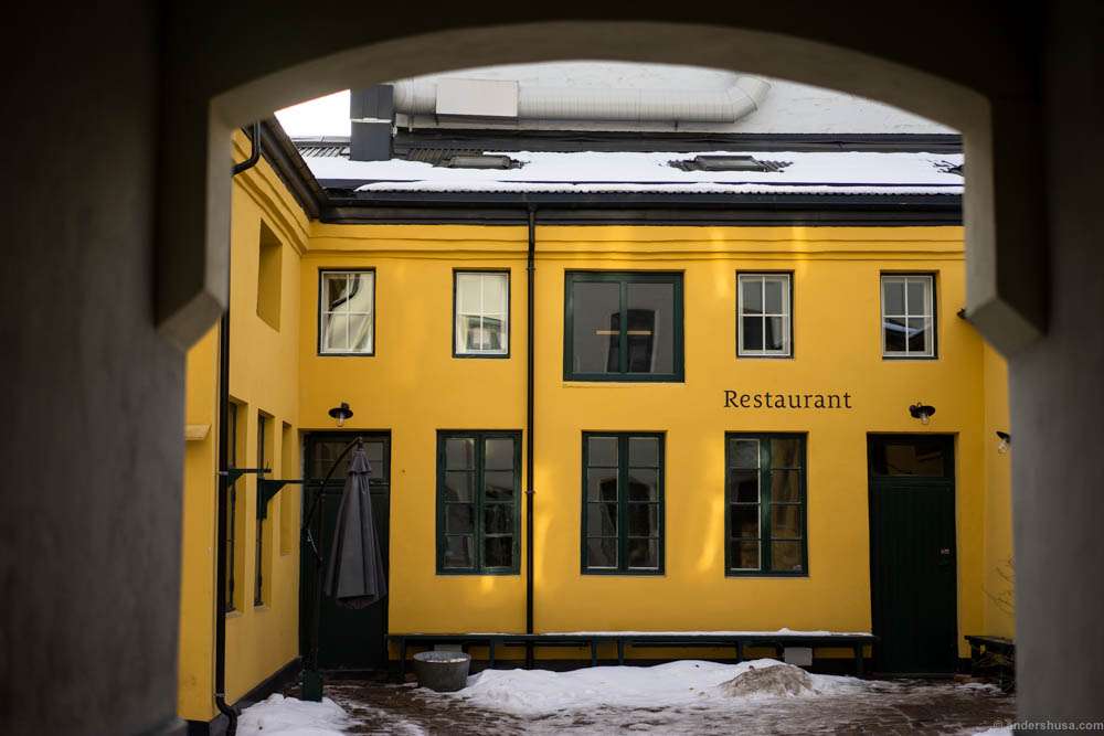 Enter through the gate to the backyard to find the restaurant
