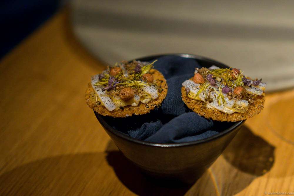 Squid, elstar apples, fermented wheat, pickled pine cones and flowers. That's one small bite for a man, but an insane explosion in your mouth!