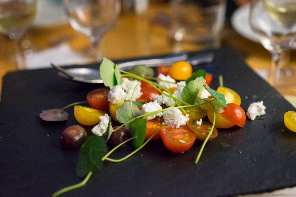 Fresh tomatoes and mozzarella cheese with nasturtium leaves and olive oil