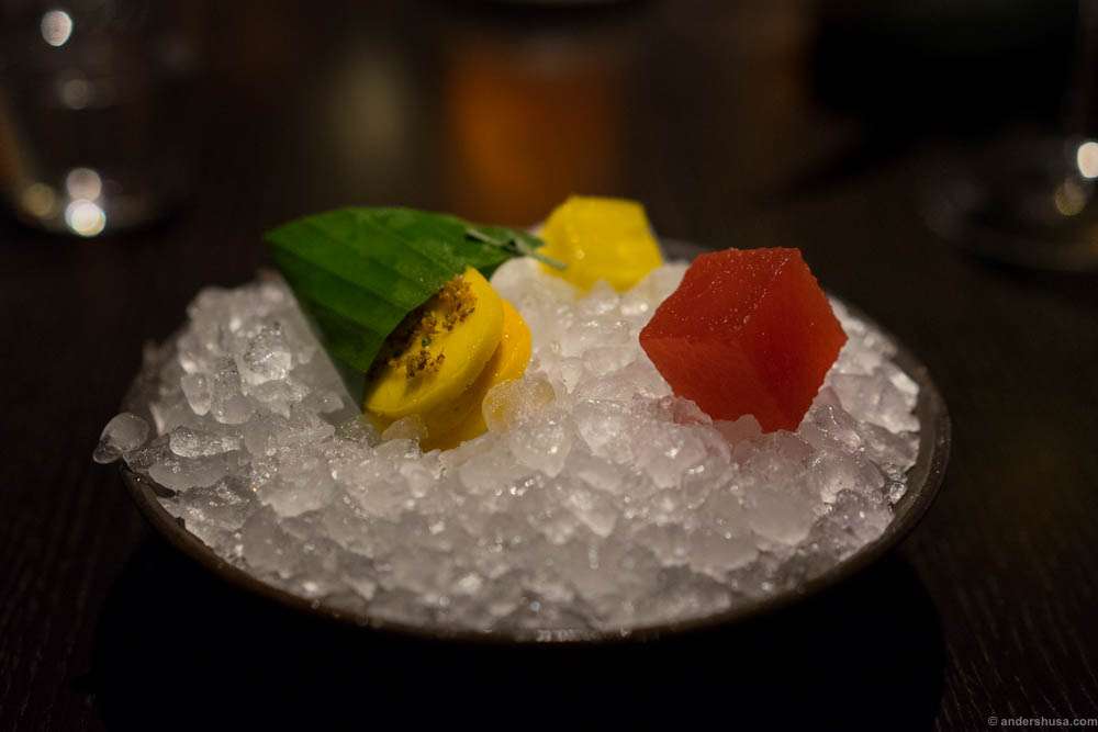 Marinated fresh fruits. Mango sandwich with mango ice cream, marinated pineapple and watermelon