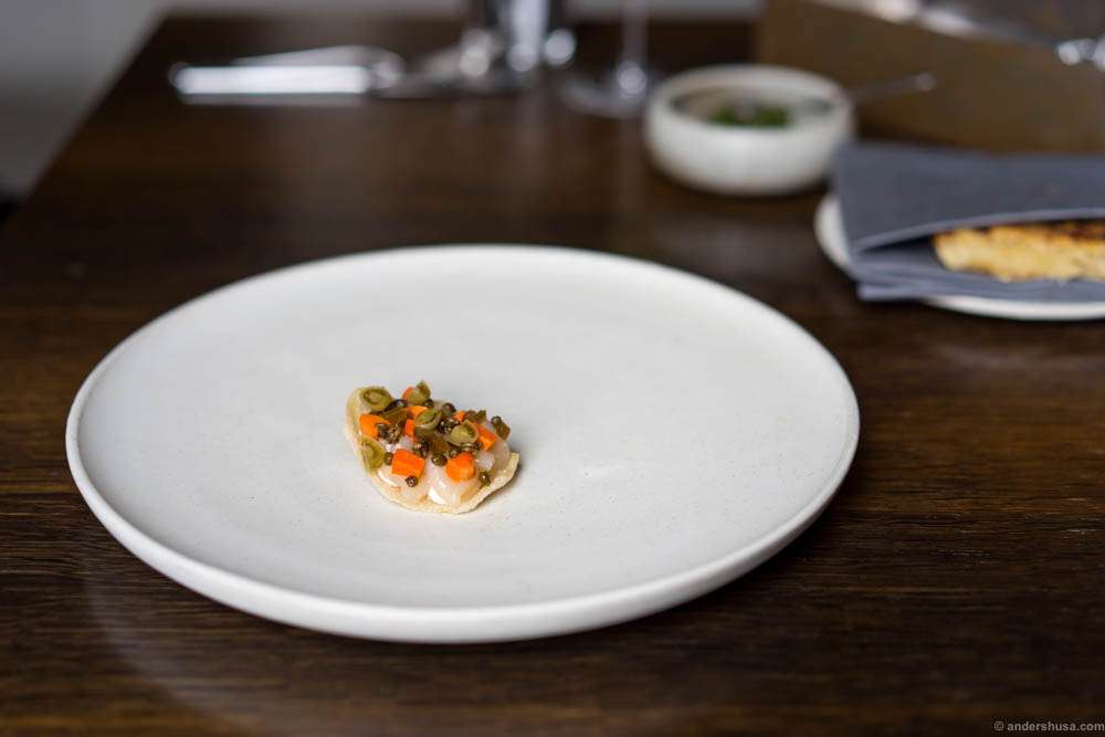 Raw Norwegian scallop, scallop row and winter pickles on crisp from day old bread and vinegar.