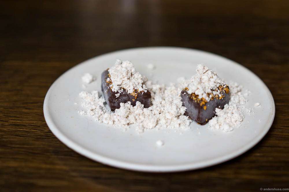 Sweet potato fudge with chocolate coating, dried seabuckthorn, and hazelnut snow.