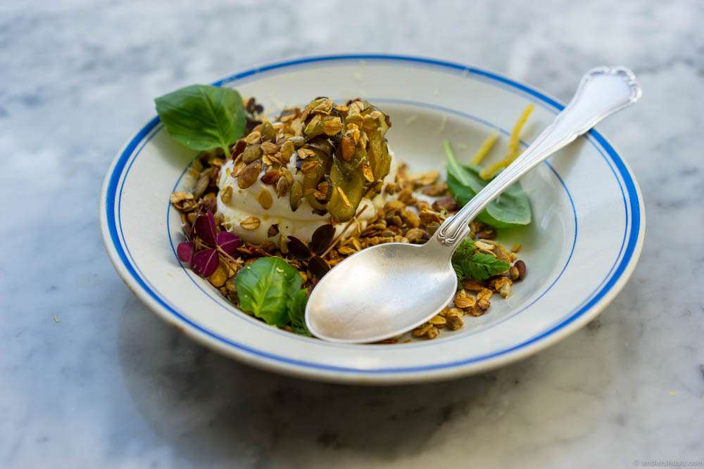 Yogurt, granola, sugar cured zucchinis, basil, lemon peel and red oxalis