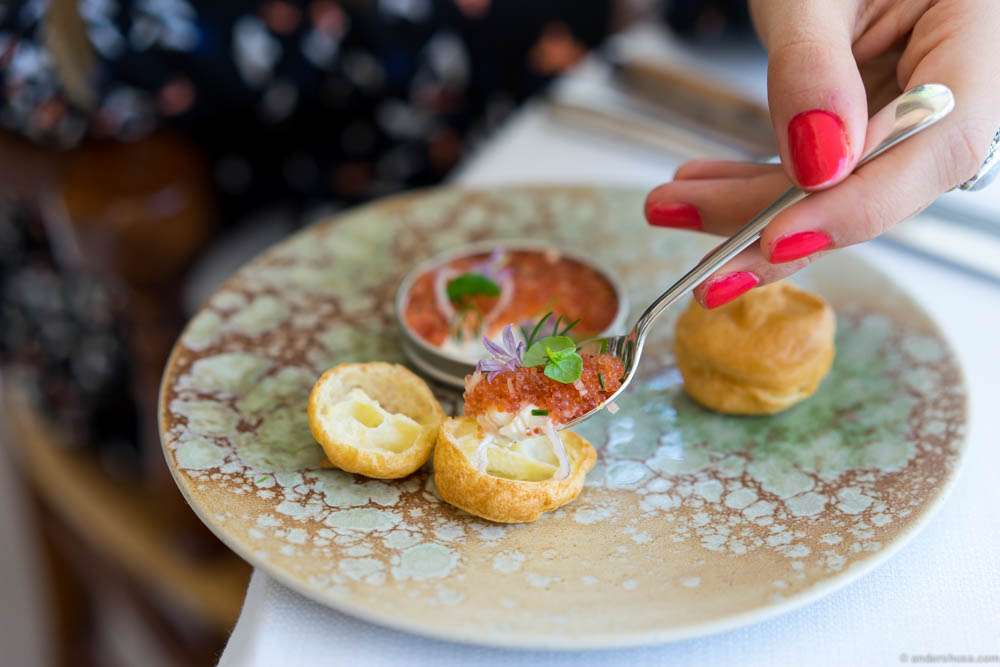 You scoop the lumpfish roe "en surprise" into the profiteroles