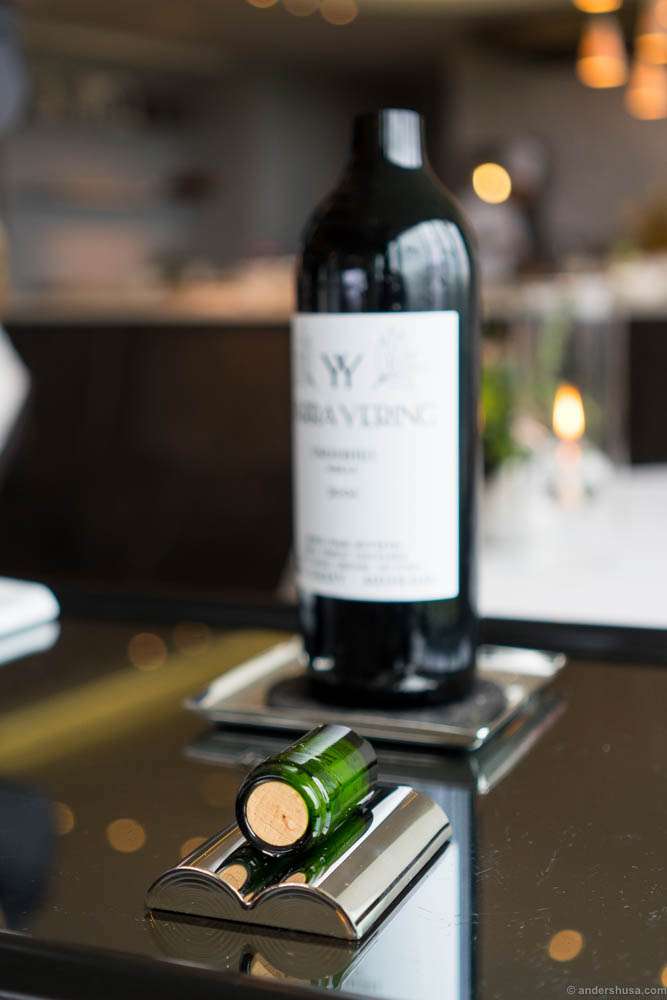 When the red hot metal is placed around the neck, it makes a clean break which leaves the cork intact