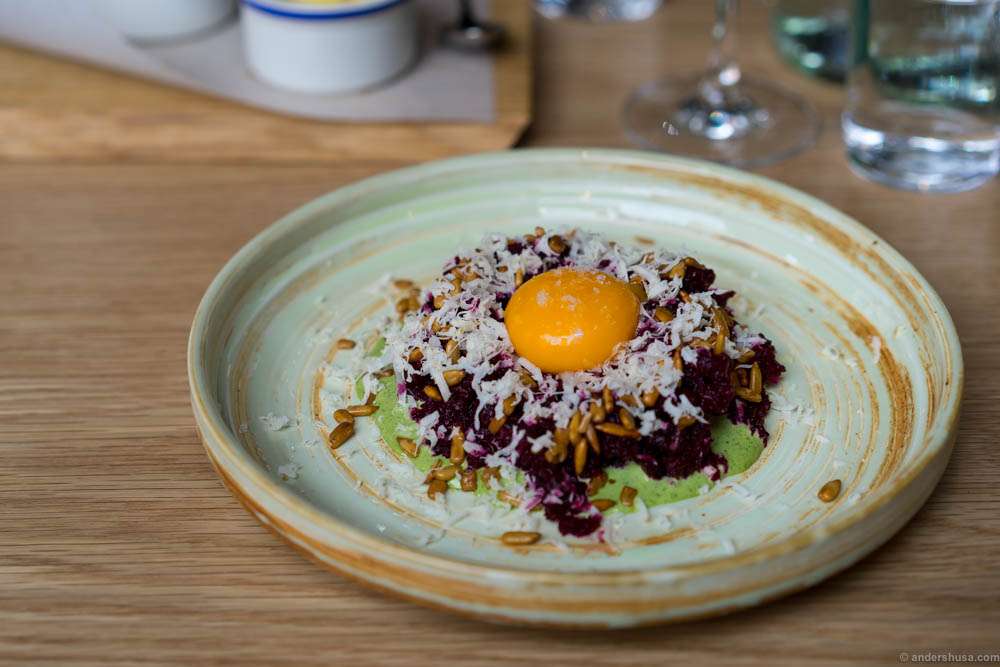 Smoked beets tartare, tarragon emulsion, roasted sunflower seeds, shaved horseradish and egg yolk at restaurant Sentralen in Oslo, Norway.