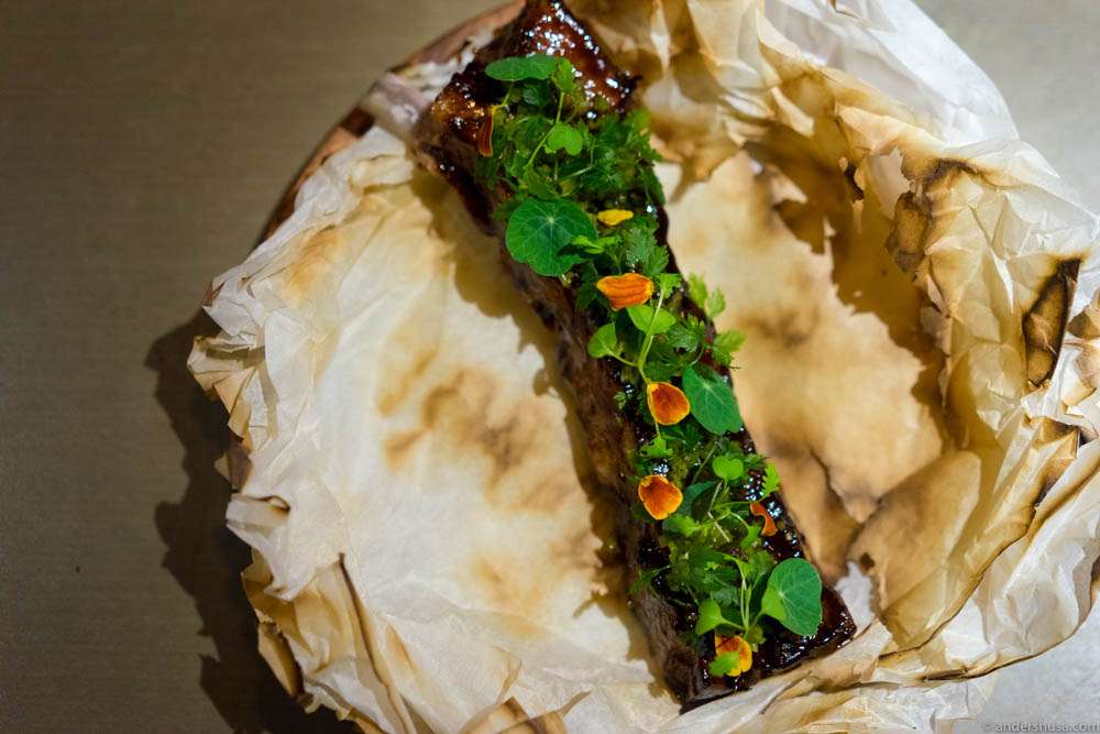 BBQ pork ribs with plum & miso glaze, capers and mustard greens