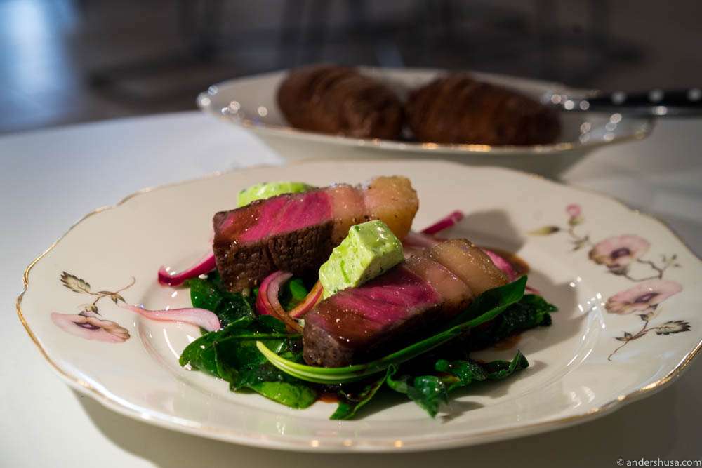 Sirloin from Scan dry aged from 13 of December. Chop of Linderöd pig from Jannelund. Ramson, spinach, pickled onions, red wine sauce, and Hasselback potatoes.