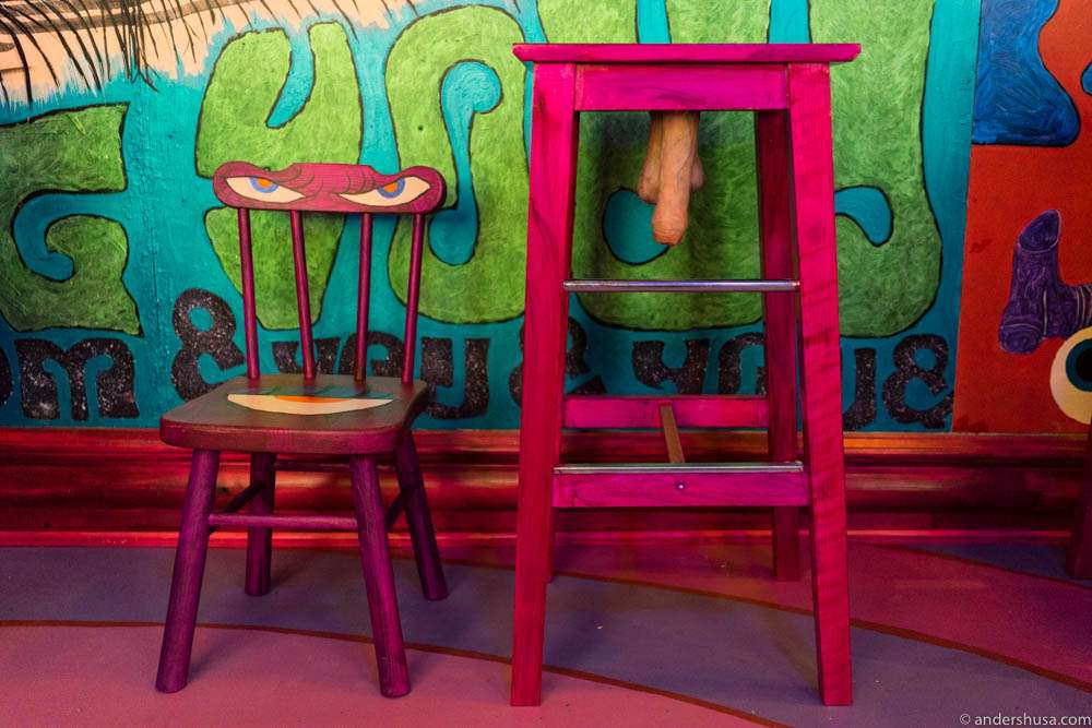 Small chairs because most people needs to be "taken down a notch," and the stools represent the fact that "there's always a dick hanging out in the bar."