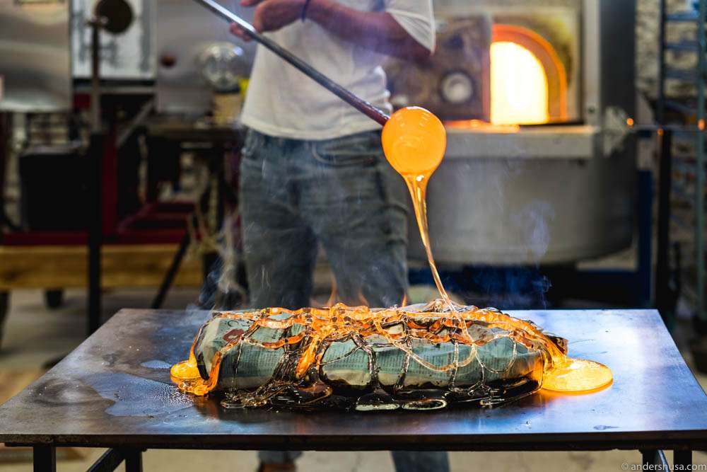 Jennie Olofsson applies a net of molten glass to the fish
