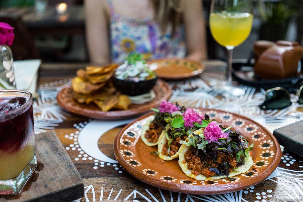 Pibil. Ancient Mayan recipe with soy protein in bitter orange, achiote, and spices. Served on handmade tortillas, black beans, lettuce & Xni Pek (habanero salsa)