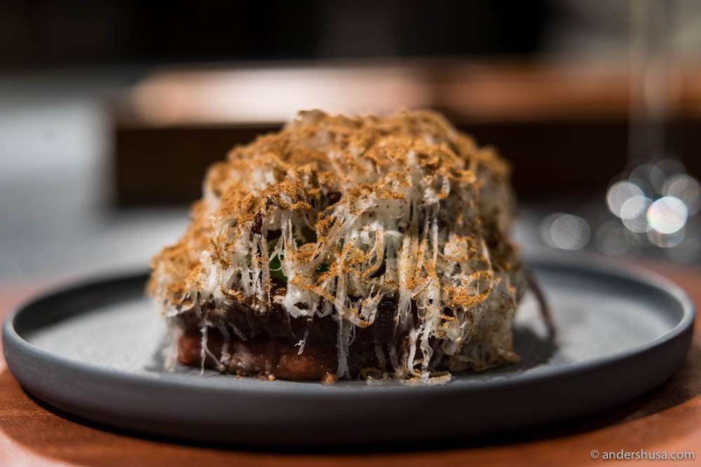 Black Angus tartar cooked with "fire oil," and served with black bread, pepper glaze, arugula mayonnaise & pickled fennel