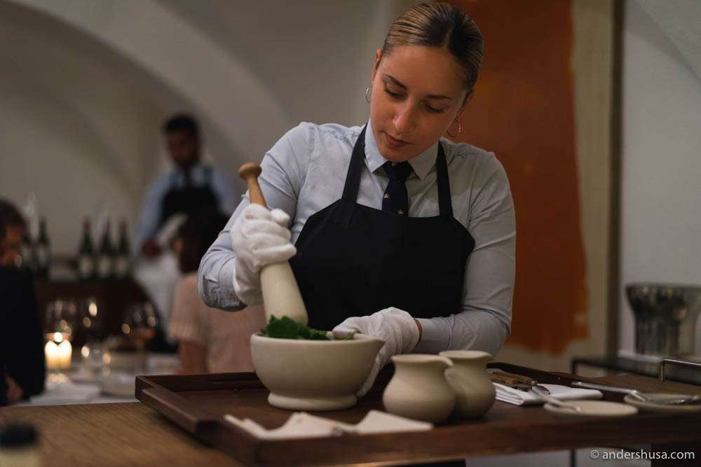 Preparing the dessert sauce with a pestel and mortar tableside