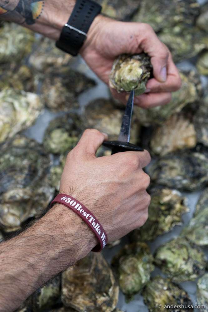 Rodrigo Belda shucking open fresh Norwegian oysters in Spain