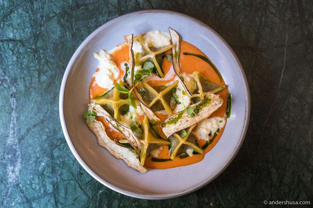 Aubergine ravioli with stracciatella and a cold tomato coulis.