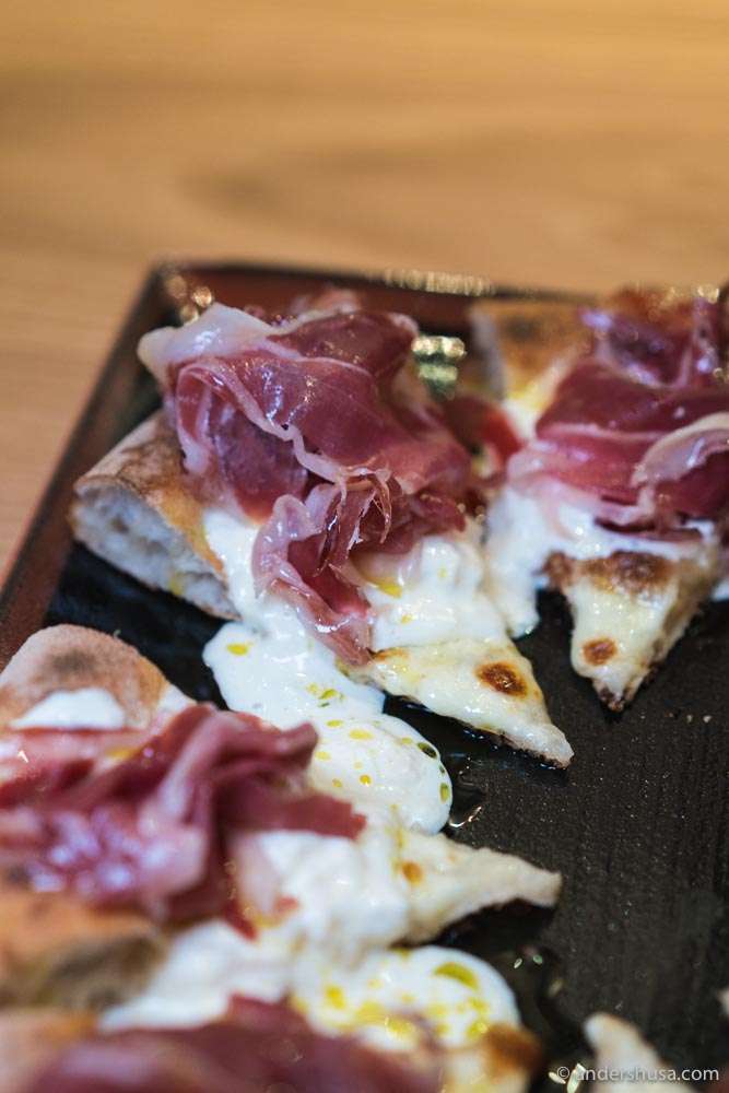 Our favorite pizza at Vinoteket is topped with pata negra and burrata.