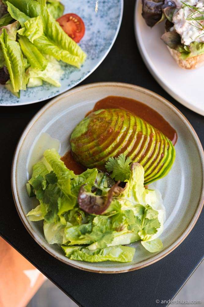 Sliced avocado with kimchi sauce.