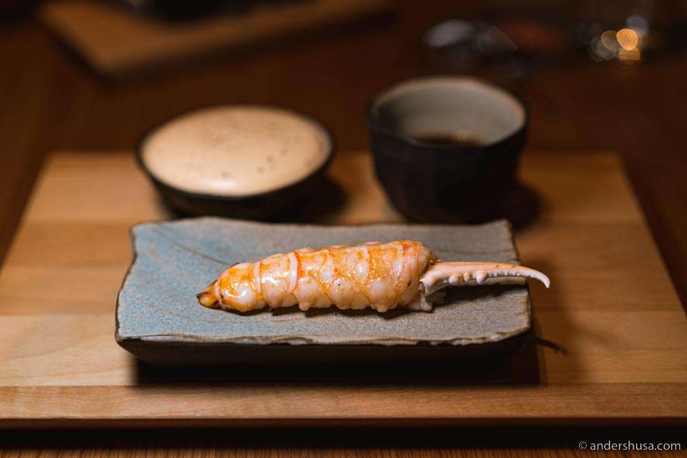Langoustine glazed with brown butter and cherry, brown butter emulsion, seaweed powder, & langoustine bouillon.