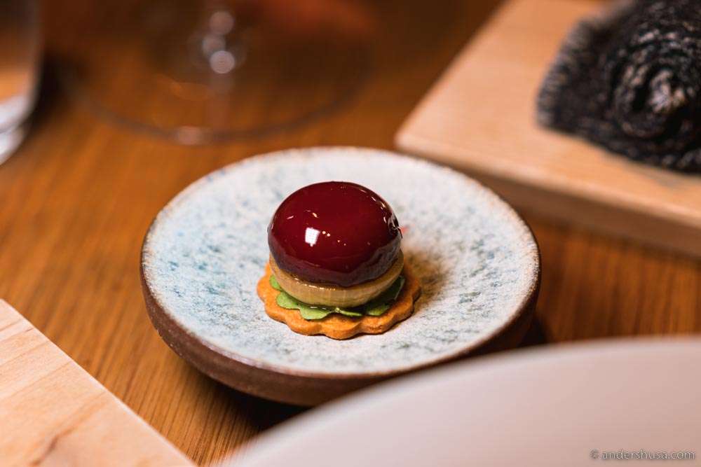 Parfait of quail liver, dipped in cherry glaze, bacon and onion chip, & caramelized onions.